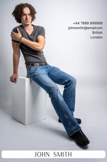 a man sitting on a white cube with a gray background