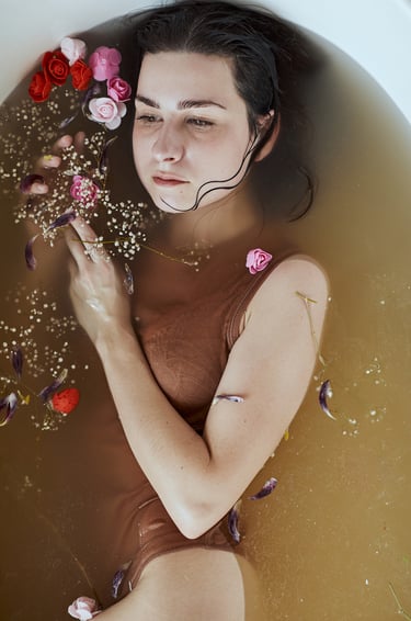a woman in a brown swimsuit is in a bathtub
