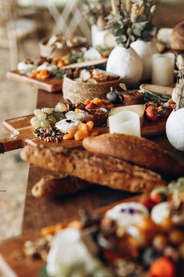 a table with a variety of cheeses and other foods
