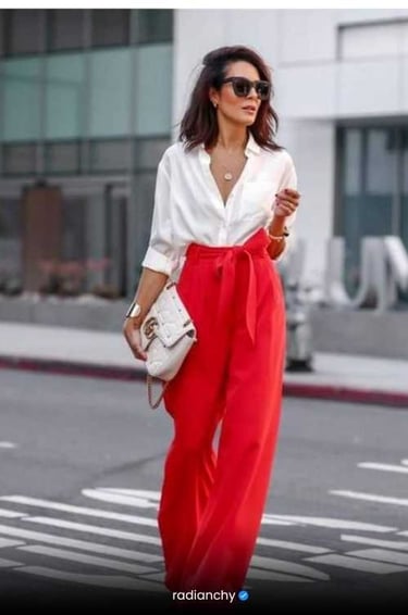 a woman in a white shirt and red pants