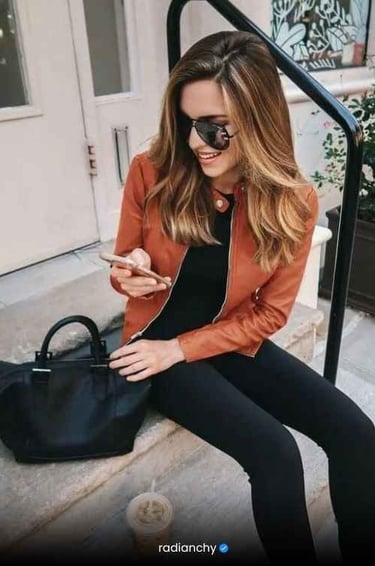 a woman in a black jacket and black pants
