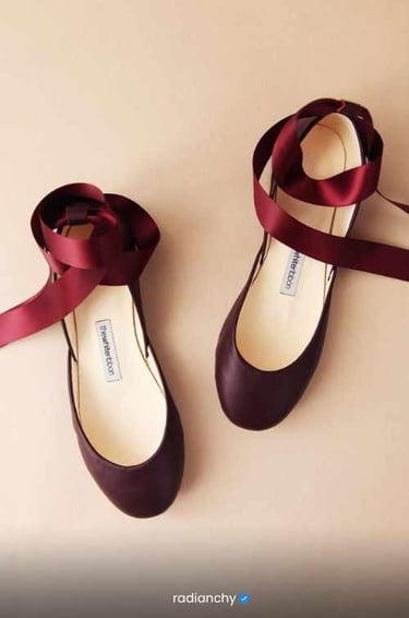 a pair of shoes with a bow tie on the side