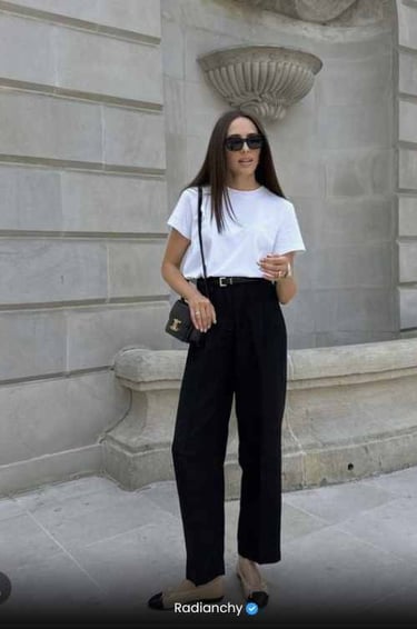 a woman in a white shirt and black pants