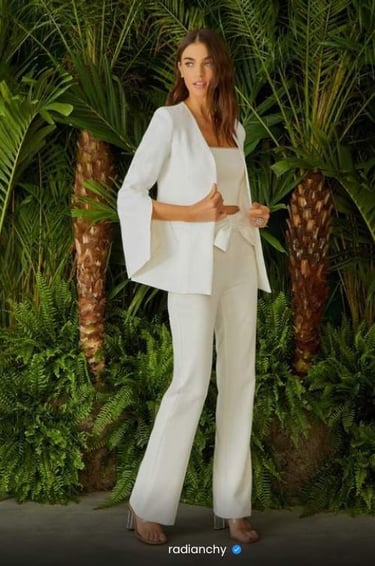 a woman in a white suit and heels