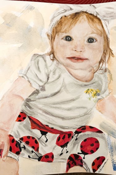 a painting of a baby's face wearing ladybug pants