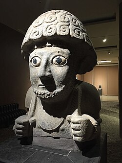 Ancient Neo-Hittite stone statue of King Suppiluliuma with large inlaid eyes on display in a museum.