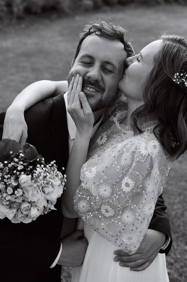 Bride kissing grooms temple.