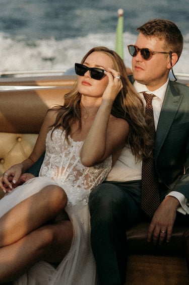 a man and woman sitting on a boat on Lake Como