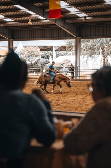 a man riding a horse in a barn