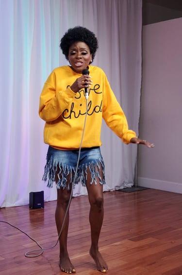 a woman in a yellow sweater and a microphone