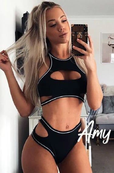 a woman in a black bikinisuit posing for a selfie