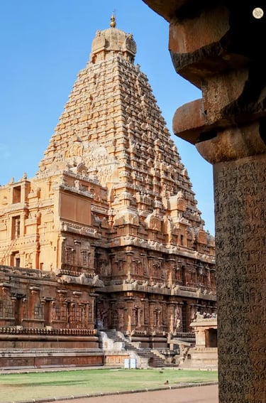 View of the Big Temple through carved pillars with ancient Tamil writing
