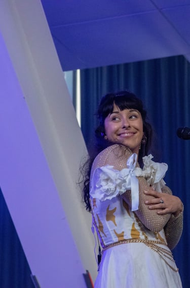 a woman in a white dress and a microphone
