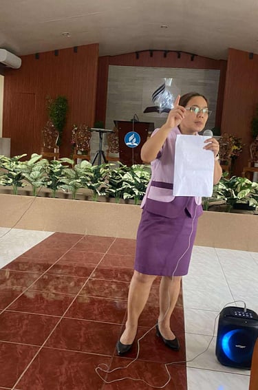Teacher with a mic talking in front 