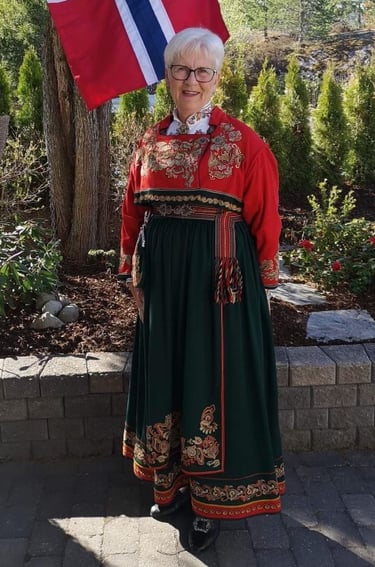 A woman with white hair in a telemark bunad