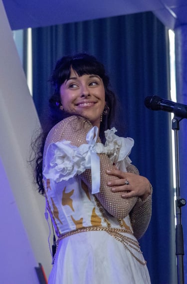 a woman in a white dress and a microphone
