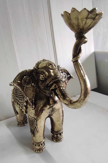 "Tribal-style brass elephant holding lotus flower, raised trunk posture, right side-Export-ready"