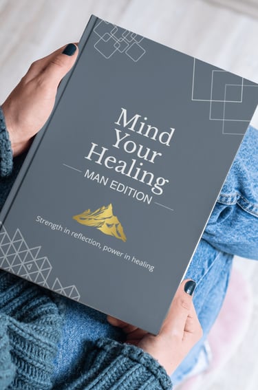 Person holding the Mind Your Healing: Man Edition guided journal for mental health and reflection.