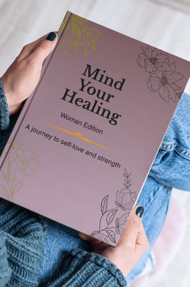 A person holding a purple Mind Your Healing self-love journal for women with floral designs.