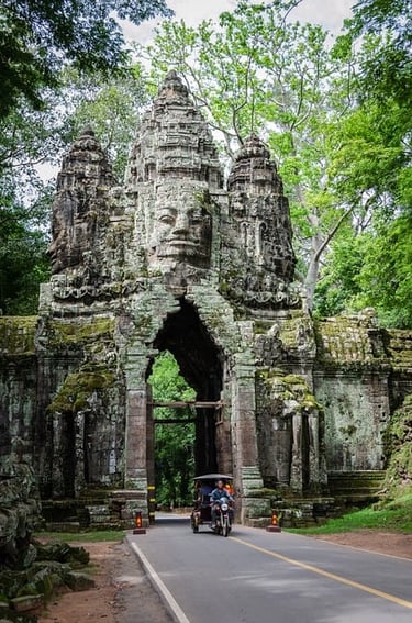 Angkor a man riding a motorcycle through a gated area