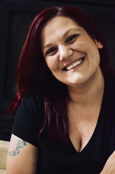 a woman with red hair smiling