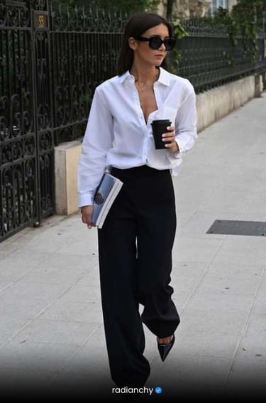 a woman in a white shirt and black pants