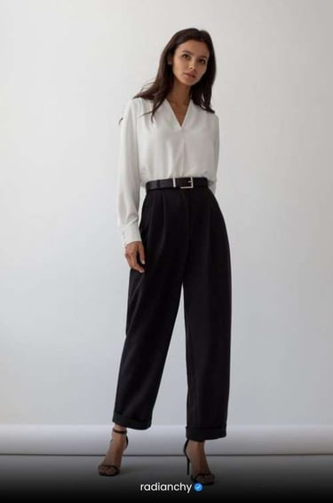 a woman in a white shirt and black pants
