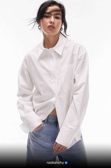 a woman in a white shirt and jeans