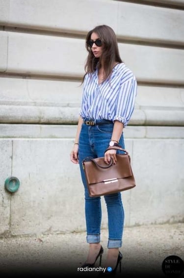 a woman in jeans and a striped shirt