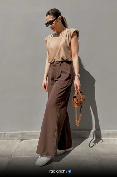 a woman in a brown shirt and brown pants