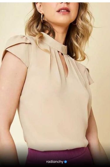 a woman in a beige top with a purple skirt