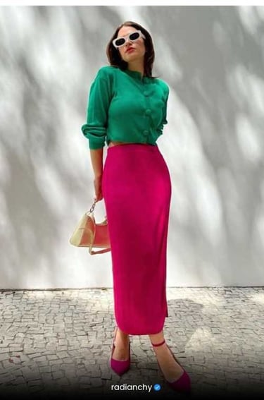 a woman in a green shirt and pink skirt