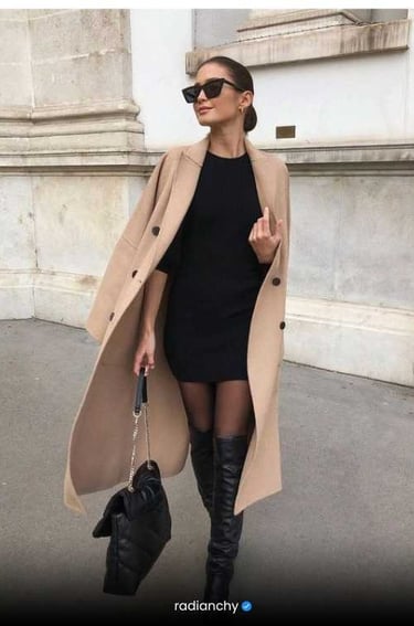a woman in a black dress and knee high boots