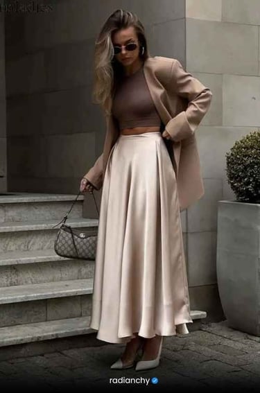 a woman in a tan coat and a tan skirt