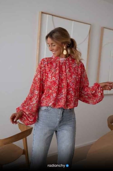 a woman in a red blouse and jeans jeans