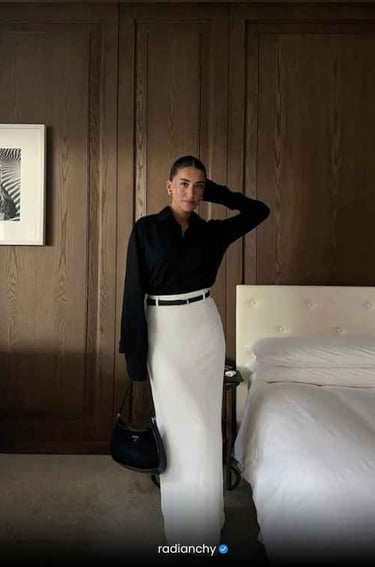 a woman in a white skirt and black shirt