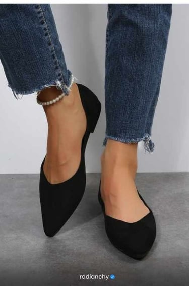 a woman's feet in jeans and pearls
