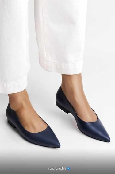 a woman's feet in white pants and white pants