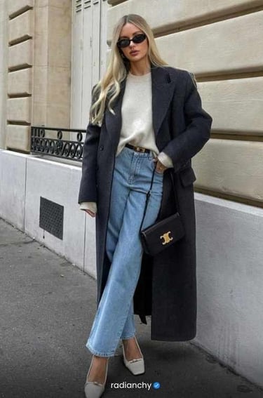 a woman in a white sweater and jeans jeans and a coat
