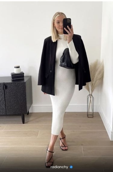 a woman in a white dress and black jacket
