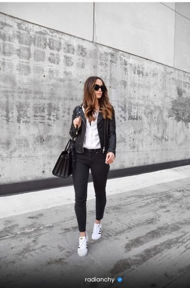 a woman in black jeans and white shirt