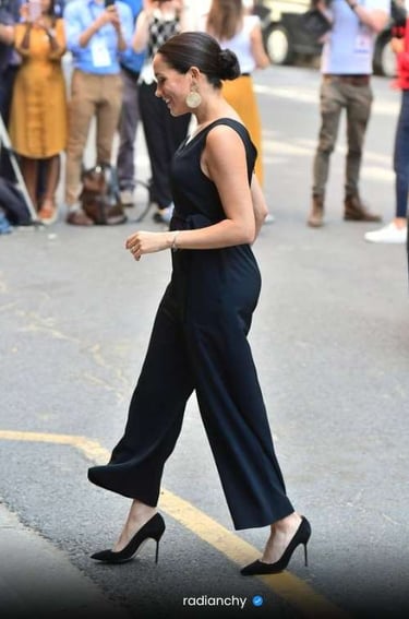 a woman in a black dress and heels