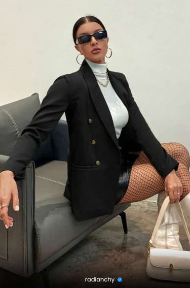a woman in a black jacket and fishnet stockings