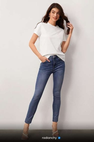 a woman in jeans and a white t - shirt