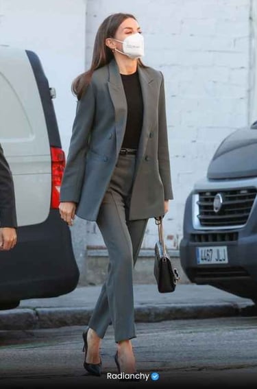 a woman in a suit and mask mask