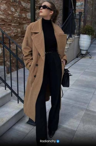 a woman in a black turtle neck sweater and black pants