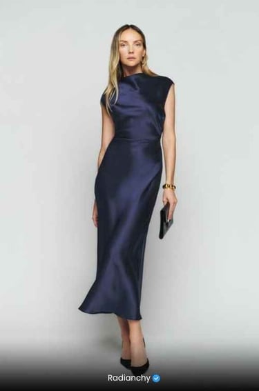 a woman in a blue dress with a clutch bag