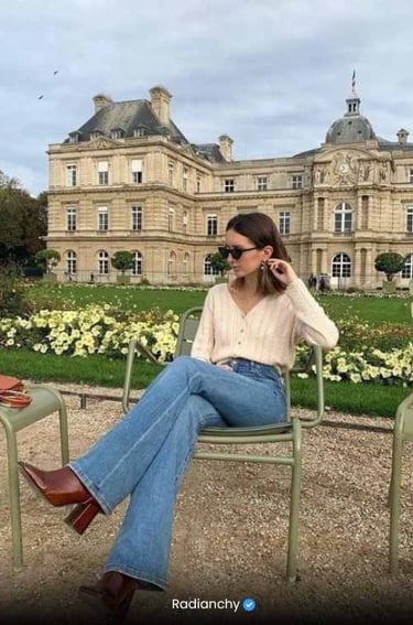 a woman sitting in a chair in front of a large building