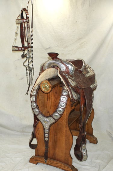 Antique brown and silver saddle that comes with matching bridle and martingale. 