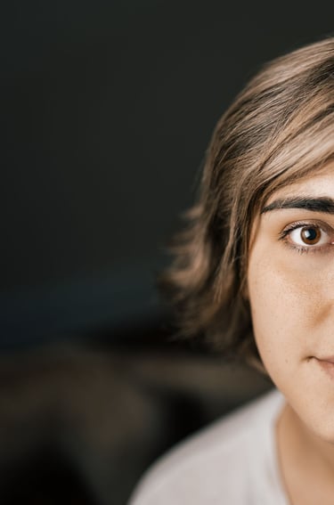 A partial image of a woman with rounded eye shapes
